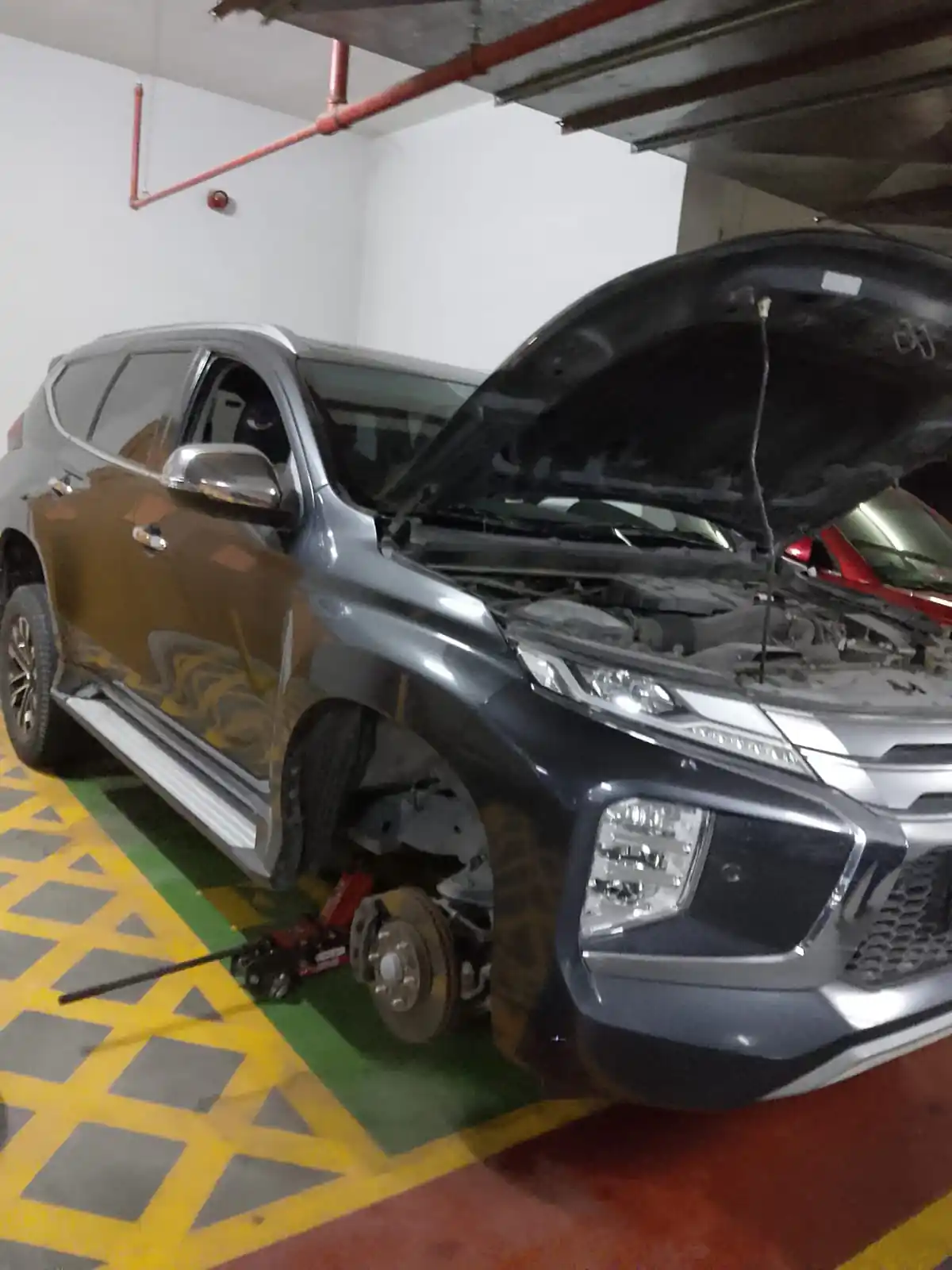Mobile technician servicing an engine bay with a full tool tray